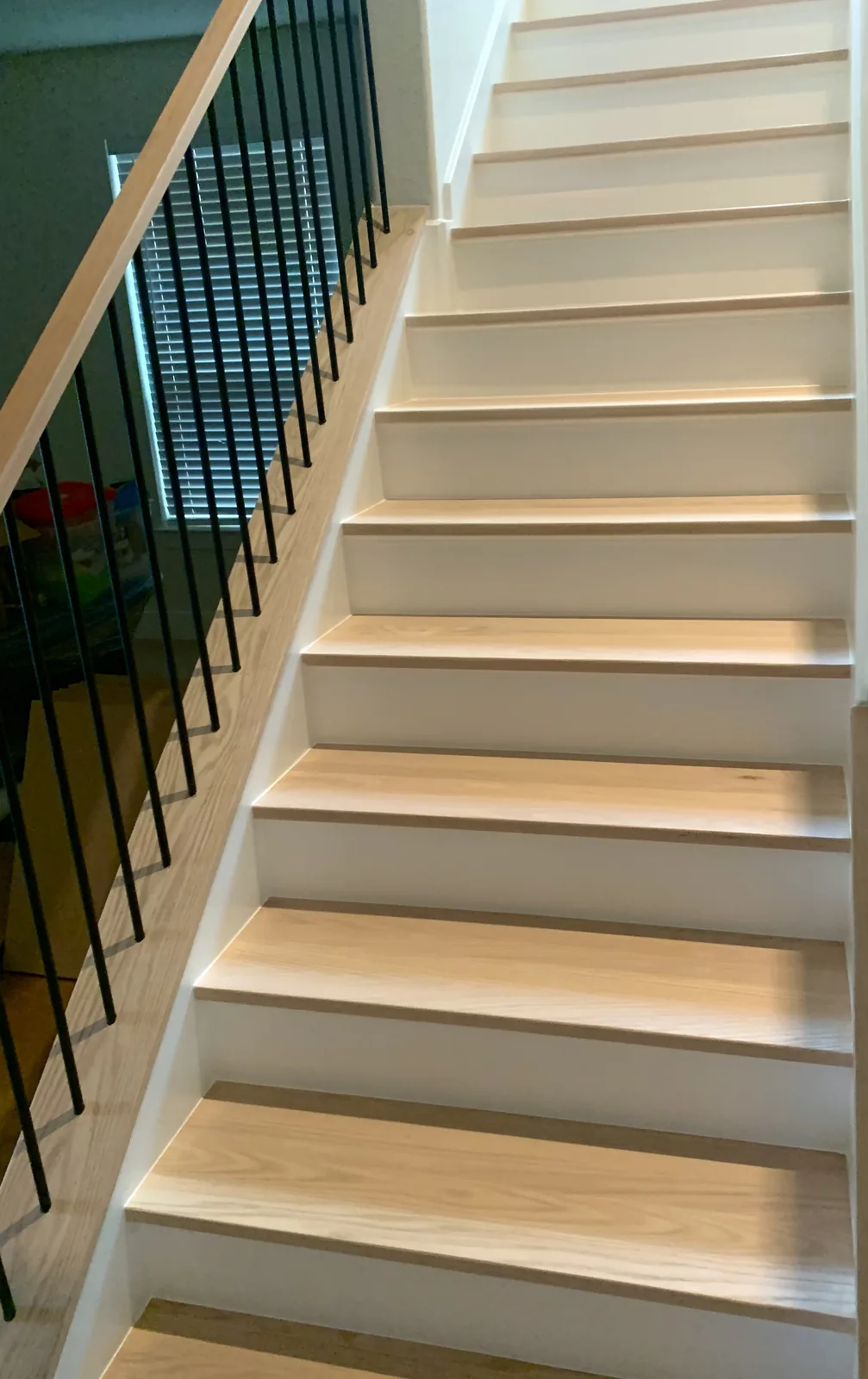 White painted staircase with dark metal balusters