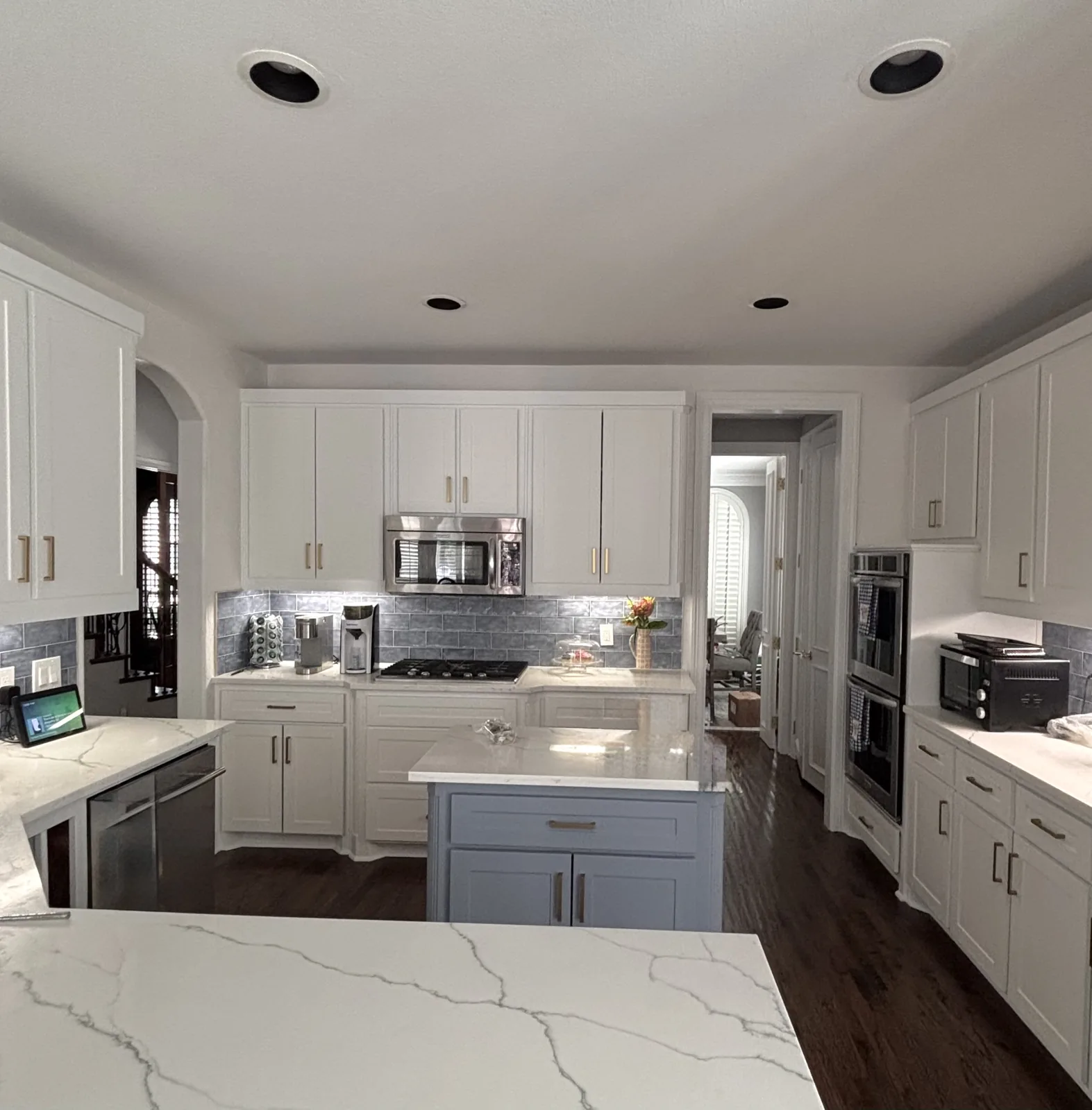 Finished white kitchen with a blue-gray island