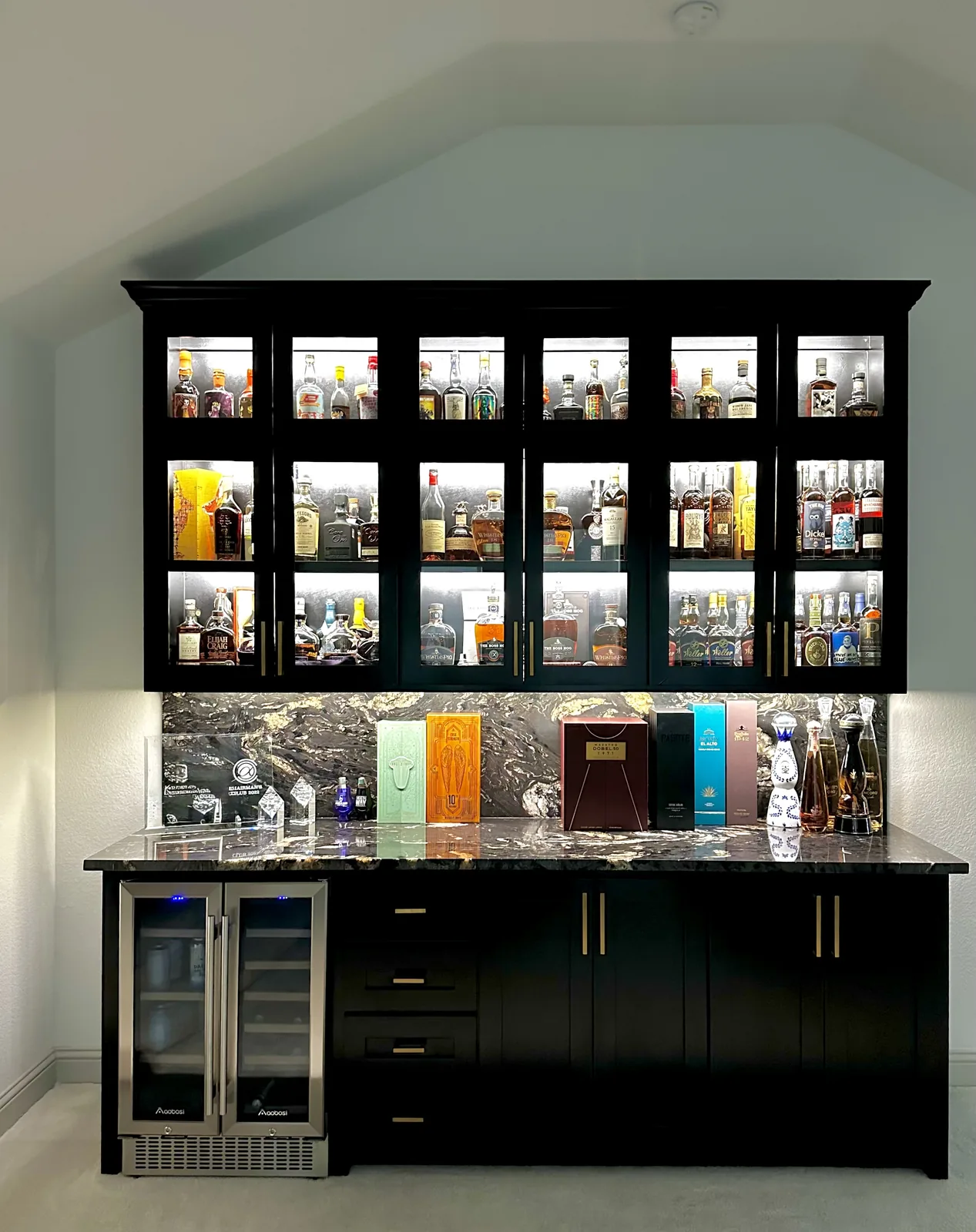 Black built-in bar cabinetry against a light finished wall