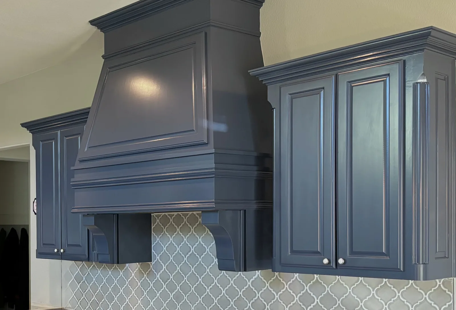 Deep blue painted kitchen cabinets and custom range hood