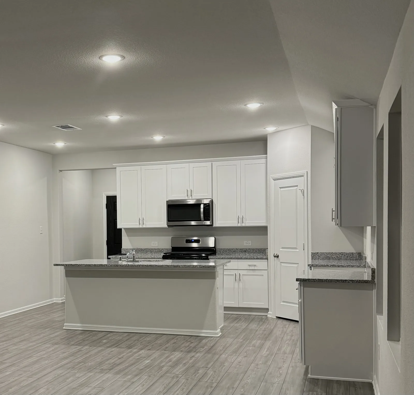Finished white kitchen with smooth walls, ceiling, trim, and cabinetry