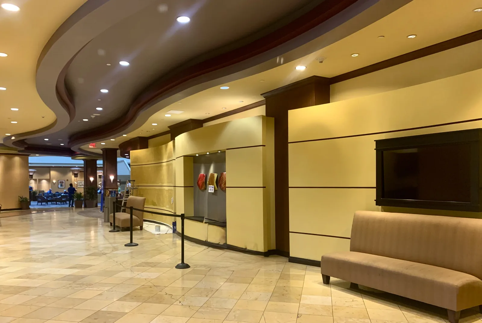 Finished commercial interior with curved ceiling details and painted wall panels