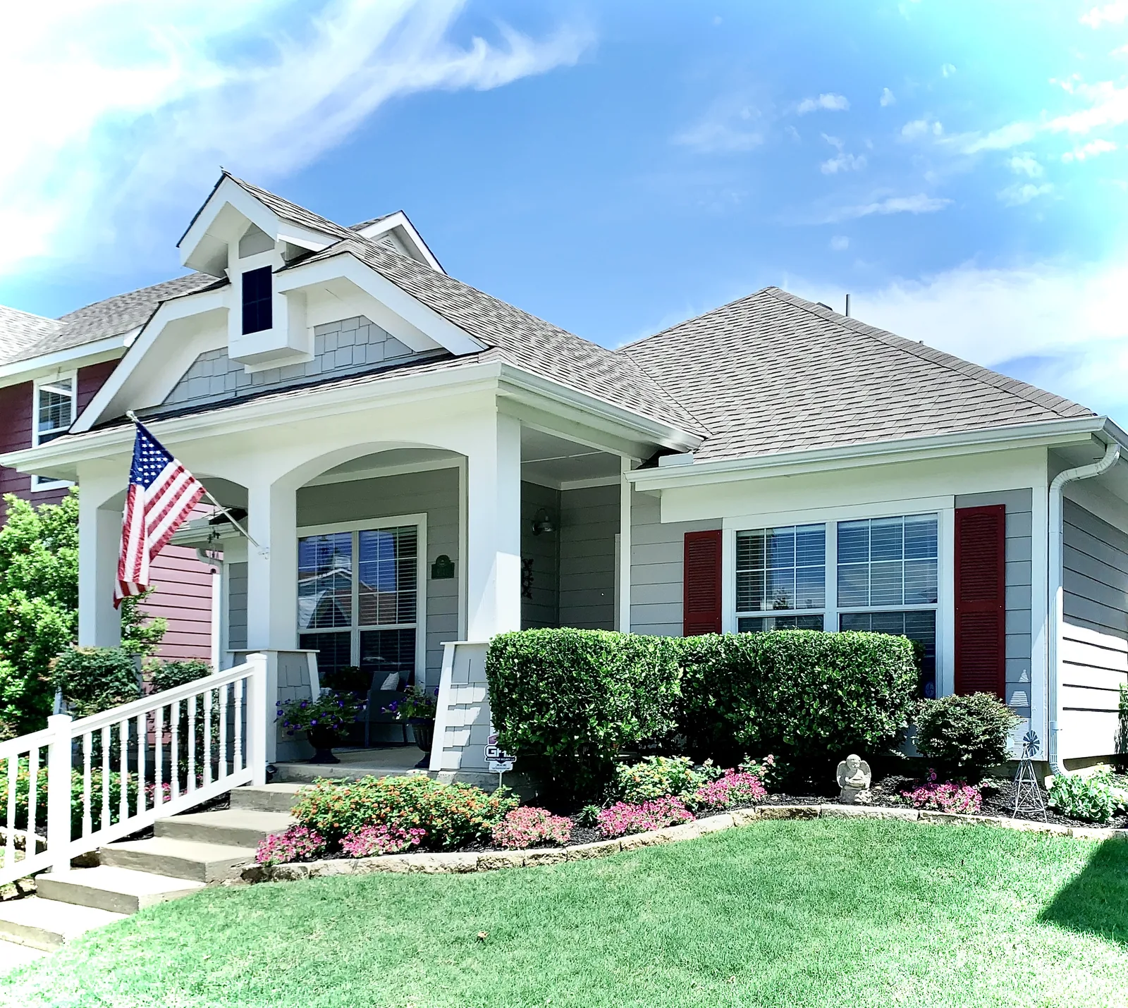 Finished home exterior with gray siding and white trim