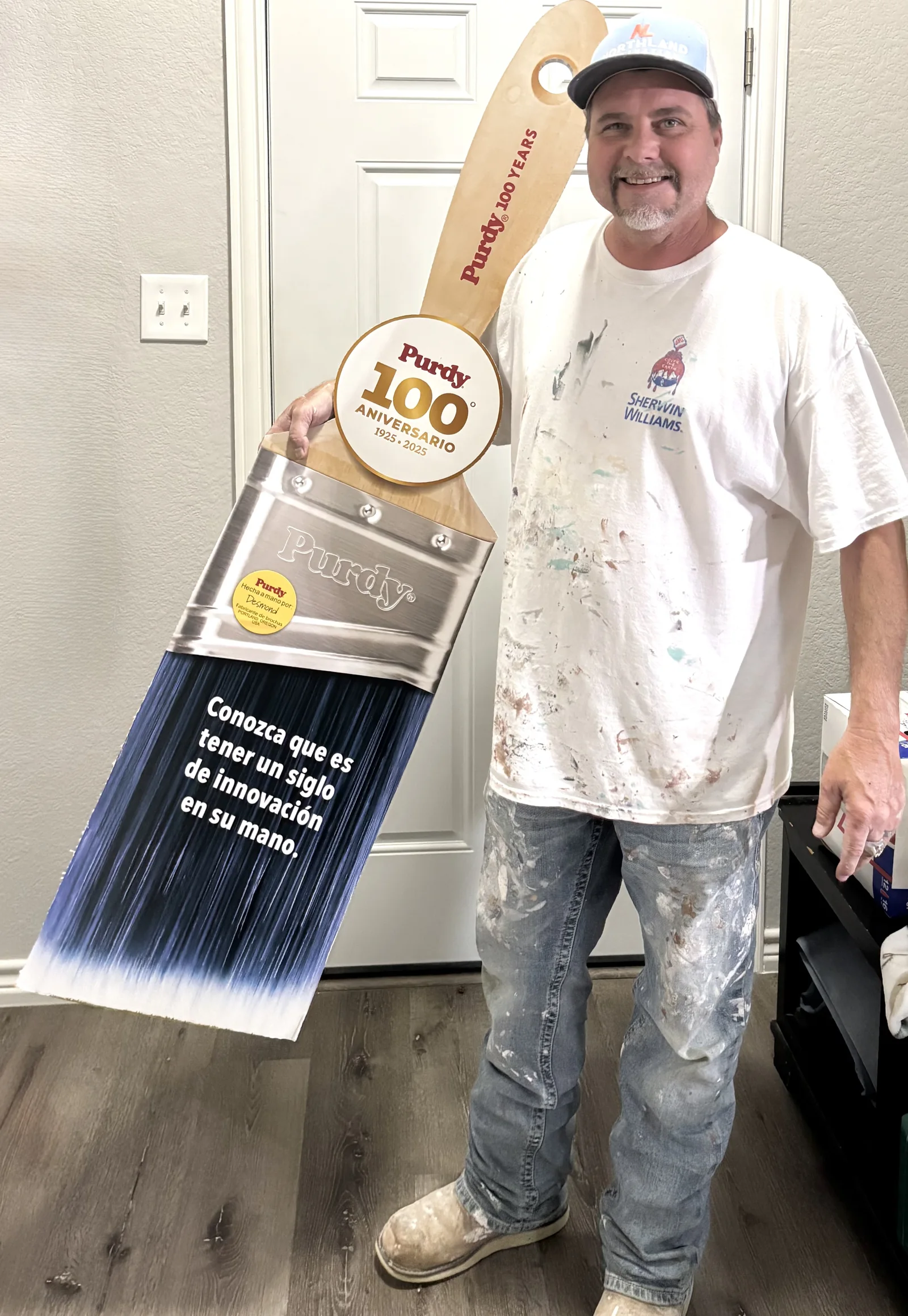 Randy Taraba holding an oversized Purdy paintbrush
